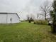 Spacious backyard with a large barn and mature trees at 3149 E 900 S, Flat Rock, IN 47234