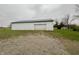 Detached garage with a large roll-up door at 3149 E 900 S, Flat Rock, IN 47234