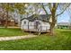 Landscaped backyard with a view of the house and trees at 700 S Ohio St, Sheridan, IN 46069