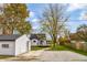 Spacious backyard with shed, trees, and gravel driveway at 700 S Ohio St, Sheridan, IN 46069