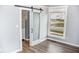 Bedroom with hardwood floors, barn door, and a closet at 700 S Ohio St, Sheridan, IN 46069