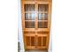 Detailed view of an antique wooden china cabinet with glass doors and drawers at 700 S Ohio St, Sheridan, IN 46069