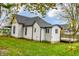 White sided home with deck and landscaping in the backyard at 700 S Ohio St, Sheridan, IN 46069