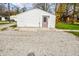 White garage with concrete slab and gravel driveway at 700 S Ohio St, Sheridan, IN 46069