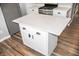 White kitchen island with quartz countertop and black hardware at 700 S Ohio St, Sheridan, IN 46069