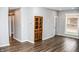 Living area featuring hardwood floors, gray walls, and built-ins at 700 S Ohio St, Sheridan, IN 46069