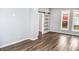 Living room with hardwood floors, barn door, and gray walls at 700 S Ohio St, Sheridan, IN 46069