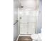 Clean white shower with sliding glass doors and built-in shelving at 700 S Ohio St, Sheridan, IN 46069