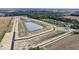 Aerial view showing new home community and pond at 7904 Magnolia St, New Palestine, IN 46163