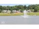 Community pond with fountain and homes in background at 7904 Magnolia St, New Palestine, IN 46163