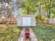 Backyard shed with brick path and autumn leaves at 11411 Shady Hollow Ln, Indianapolis, IN 46229