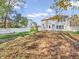 Large backyard with patio, autumn leaves, and white fence at 11411 Shady Hollow Ln, Indianapolis, IN 46229