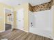 Bathroom with shower/tub combo, tile surround, and vinyl flooring at 11411 Shady Hollow Ln, Indianapolis, IN 46229