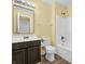Bathroom with dark vanity, toilet, and bathtub at 11411 Shady Hollow Ln, Indianapolis, IN 46229