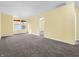 Large carpeted bedroom with two windows and ceiling fan at 11411 Shady Hollow Ln, Indianapolis, IN 46229