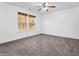 Bright bedroom with ceiling fan, carpet, and two windows at 11411 Shady Hollow Ln, Indianapolis, IN 46229