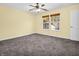 Bedroom with ceiling fan, carpet, and two windows at 11411 Shady Hollow Ln, Indianapolis, IN 46229