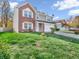 Two-story brick home with attached garage and landscaping at 11411 Shady Hollow Ln, Indianapolis, IN 46229