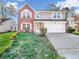 Two-story brick home with a two-car garage and landscaping at 11411 Shady Hollow Ln, Indianapolis, IN 46229