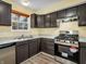 Updated kitchen featuring dark wood cabinets and stainless steel appliances at 11411 Shady Hollow Ln, Indianapolis, IN 46229