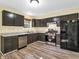 Modern kitchen with dark cabinets, stainless steel appliances, and light countertops at 11411 Shady Hollow Ln, Indianapolis, IN 46229