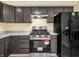 Stainless steel appliances and dark cabinets are featured in this kitchen at 11411 Shady Hollow Ln, Indianapolis, IN 46229