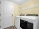 Laundry room with washer, dryer, and ample shelving at 11411 Shady Hollow Ln, Indianapolis, IN 46229