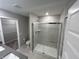 Bathroom with walk-in shower and gray tile at 1202 Langham St, Avon, IN 46123