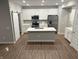 Open concept kitchen with island and stainless steel appliances at 1202 Langham St, Avon, IN 46123