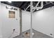 Unfinished basement area with exposed pipes and concrete floor at 3805 Byram Ave, Indianapolis, IN 46208