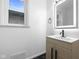 Updated bathroom with a lighted mirror and modern vanity at 3805 Byram Ave, Indianapolis, IN 46208