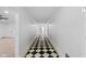 Long hallway with a black and white checkered floor at 3805 Byram Ave, Indianapolis, IN 46208