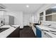 Modern kitchen with blue dishwasher and black farmhouse sink at 3805 Byram Ave, Indianapolis, IN 46208