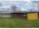 Brick home with a yellow fence and grassy yard at 3936 Delmont Dr, Indianapolis, IN 46235