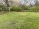 Large backyard with grassy area and trees at 3936 Delmont Dr, Indianapolis, IN 46235