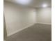 Unfinished basement with neutral carpeting and an interior door at 3936 Delmont Dr, Indianapolis, IN 46235