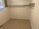 Small closet with tile flooring and a hanging rod at 3936 Delmont Dr, Indianapolis, IN 46235