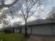 Brick ranch home with attached garage and landscaped lawn at 3936 Delmont Dr, Indianapolis, IN 46235