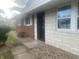Front entrance with brick and stone facade, and a security door at 3936 Delmont Dr, Indianapolis, IN 46235