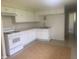 Kitchen with white cabinets, tile floor, and gas range at 3936 Delmont Dr, Indianapolis, IN 46235