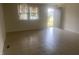 Spacious living room featuring tile floors and an exterior door at 3936 Delmont Dr, Indianapolis, IN 46235