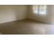 Living room with tile floor and large window at 3936 Delmont Dr, Indianapolis, IN 46235