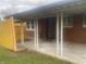 Covered patio with brick walls and concrete floor at 3936 Delmont Dr, Indianapolis, IN 46235