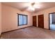 Well-lit bedroom with ceiling fan and neutral carpeting at 4257 Tattersall Dr, Plainfield, IN 46168