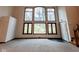 Bright living room with wall-to-wall windows and wooded views at 4257 Tattersall Dr, Plainfield, IN 46168