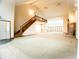 High-ceilinged living room with staircase, and views to kitchen and backyard at 4257 Tattersall Dr, Plainfield, IN 46168