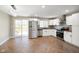 Modern kitchen with stainless steel appliances and herringbone wood floors at 70 Lincoln Ct, Franklin, IN 46131