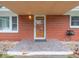 Covered entry with brick exterior and a tiled entryway at 7125 Linden Dr, Indianapolis, IN 46227