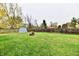 Spacious backyard with storage shed and wood pile at 7922 S Sherman Dr, Indianapolis, IN 46237