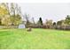 Spacious backyard with storage shed and wood pile at 7922 S Sherman Dr, Indianapolis, IN 46237